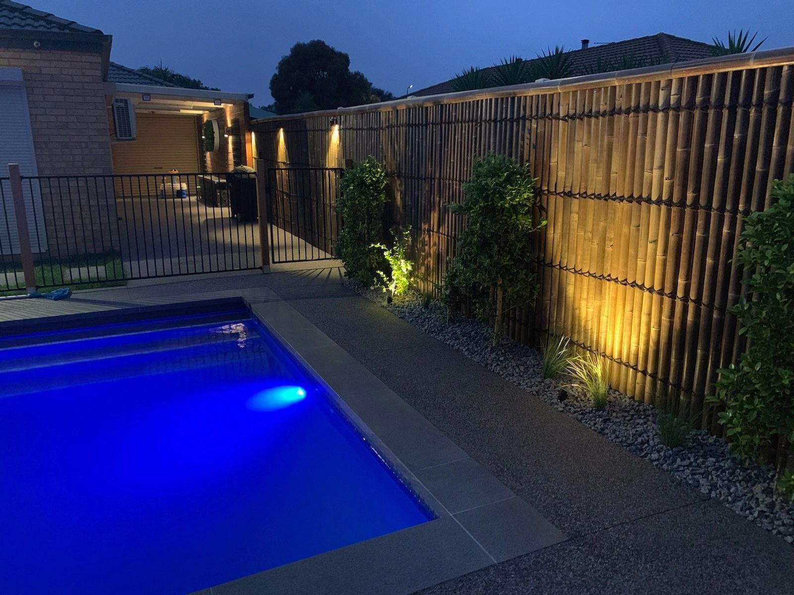Outdoor pool with garden uplights